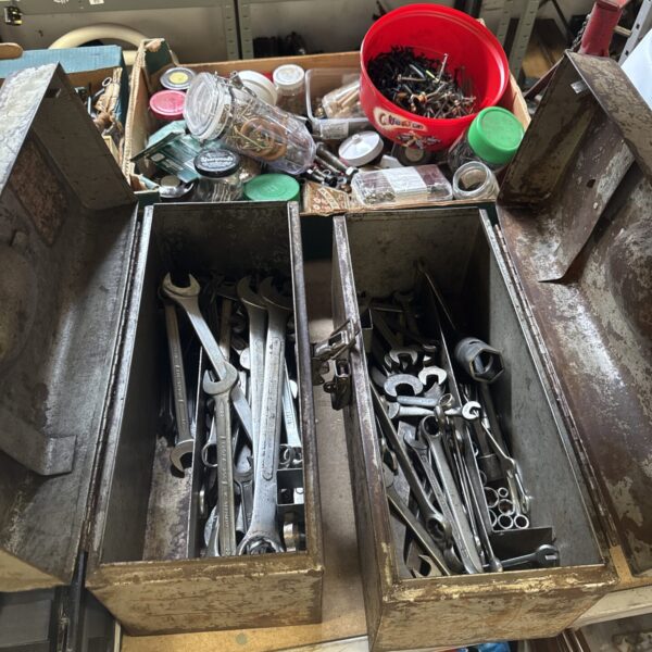 Vintage metal toolboxes filled with spanners and workshop tools.