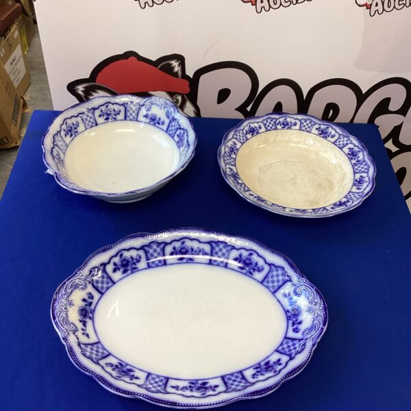 Vintage blue and white porcelain dish with willow pattern.