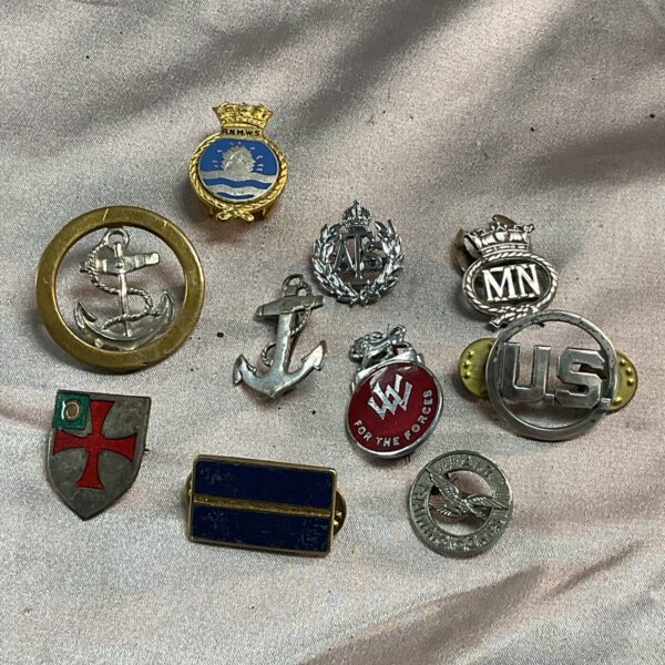 Collection of vintage WWII military badges and insignia.