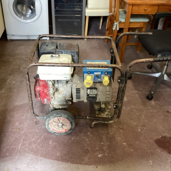 Side view of a used Stephill petrol generator on wheels.
