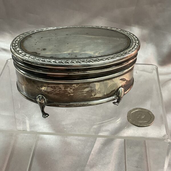 Antique sterling silver trinket pot with embossed detailing.