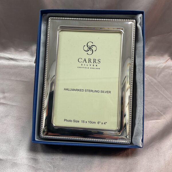 Hallmarked silver photo frame by Carrs Sheffield in original box.