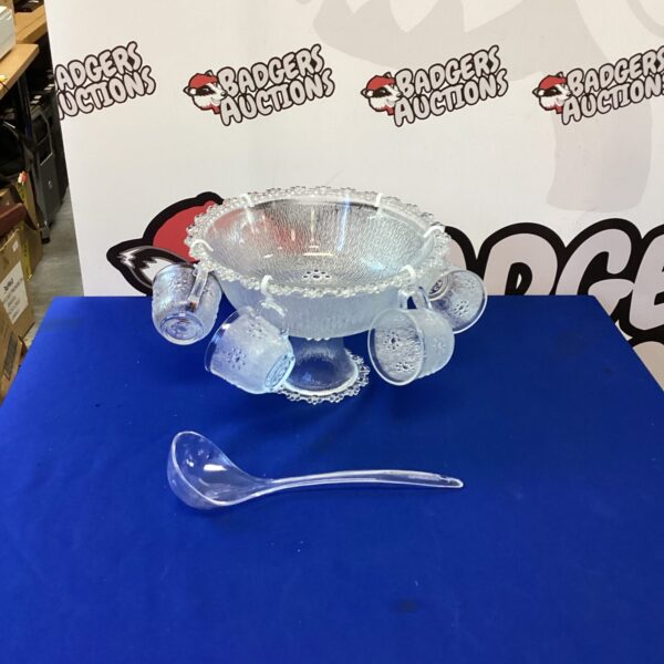Vintage glass punch bowl set with embossed details and ladle.