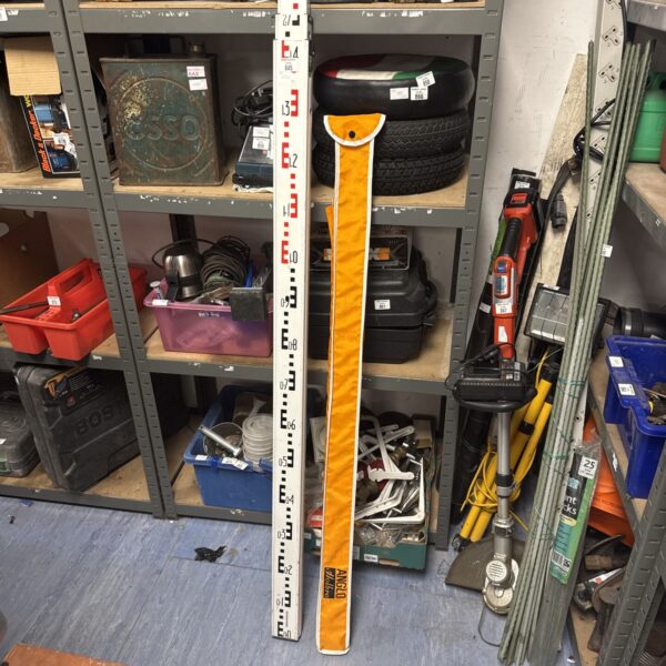 Yellow telescopic surveyor measuring rod for land surveying.