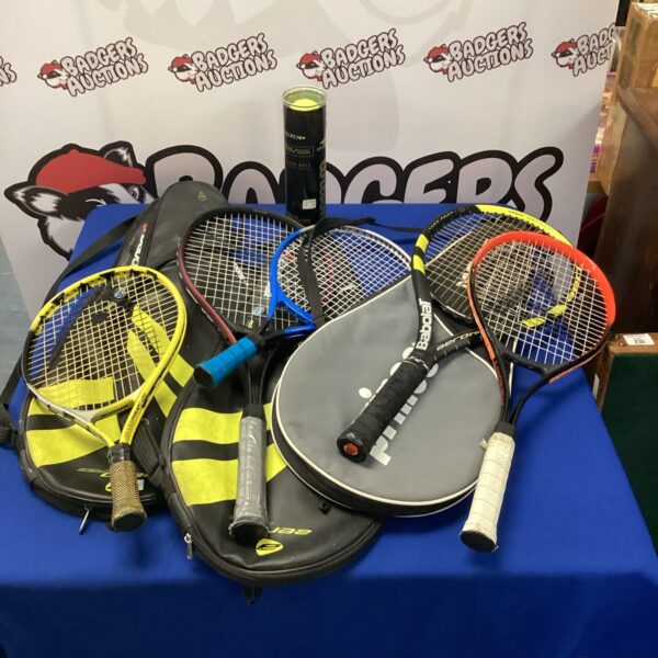 Selection of tennis rackets and balls in a sports bag.