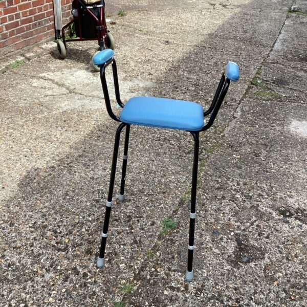 Vintage adjustable high stool with blue seat.