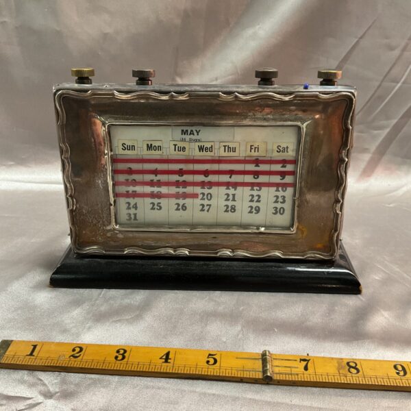 Vintage silver day date desk calendar with adjustable date display.