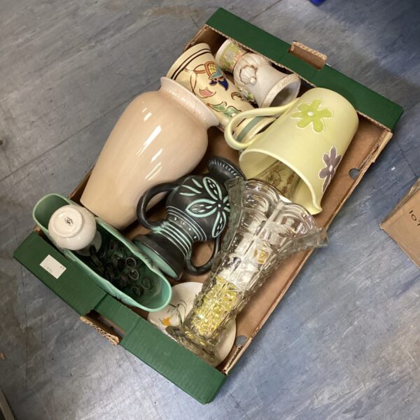 Mixed collection of vintage ceramic jugs and vases for display.