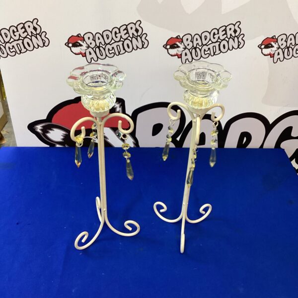 Ornate vintage metal candle holders, a classic decorative pair.