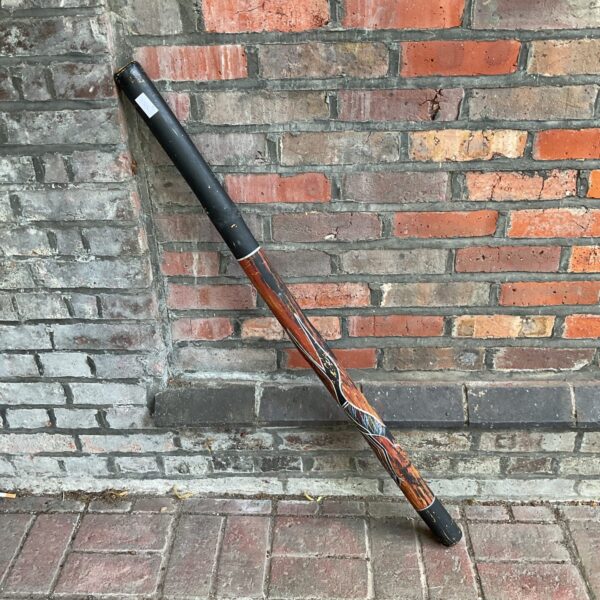 Hand-painted Aboriginal didgeridoo, traditional Australian musical instrument.
