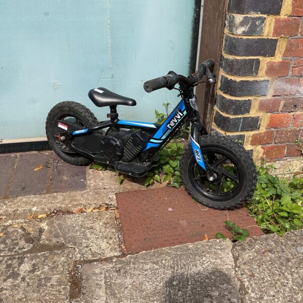 Red and black Revvi balance bike for kids.