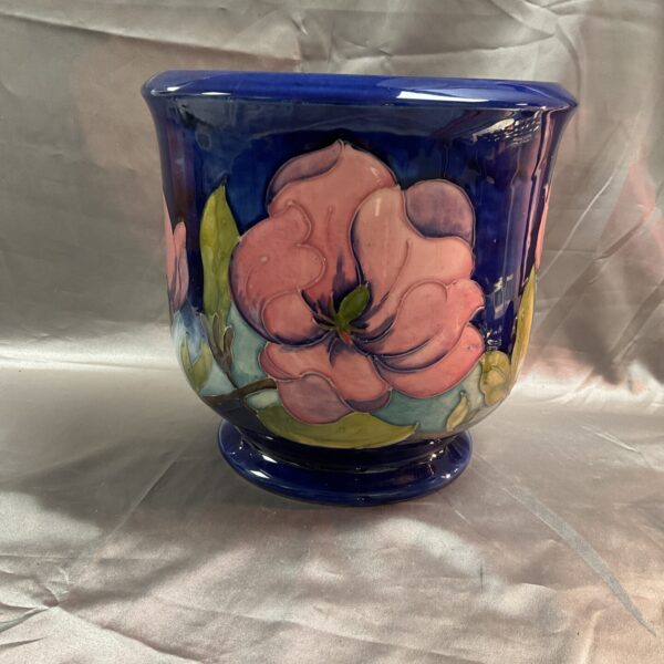 Front view of a blue Moorcroft magnolia jardinier with floral design.