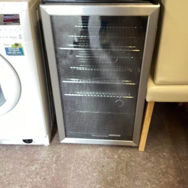 Compact wine fridge with a glass door for beverage cooling.
