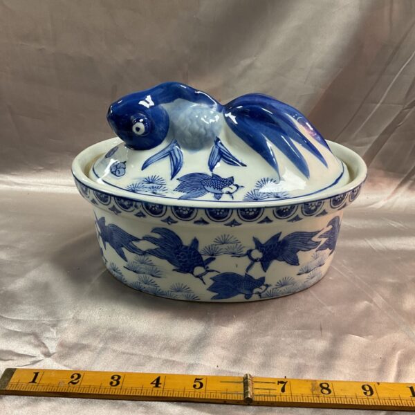 Vintage blue and white ceramic pie dish with koi fish design.