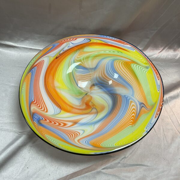 Vibrant multicoloured Murano glass dish with a swirling pattern.