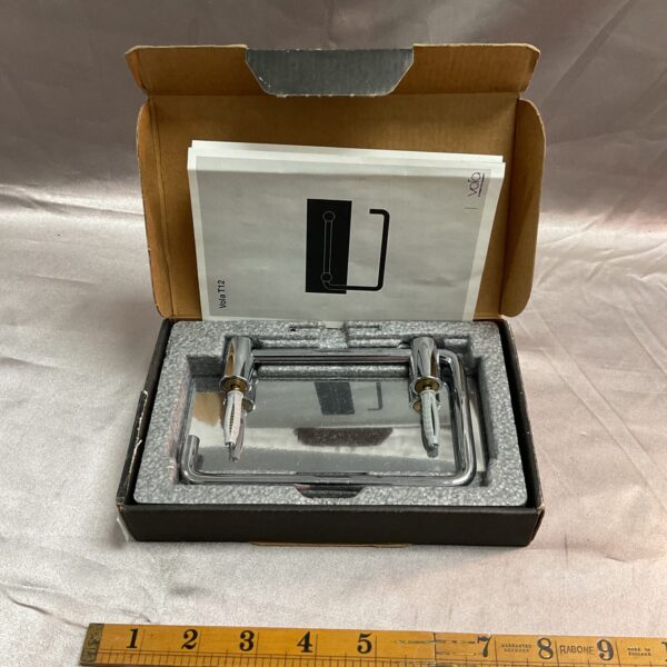 Chrome Arne Jacobsen Vola toilet roll holder in packaging.