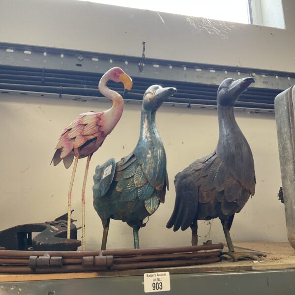 Vintage metal flamingo and heron garden ornaments for outdoor display.
