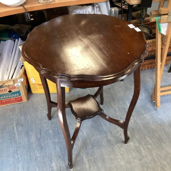 Antique Victorian mahogany side table with curved legs.