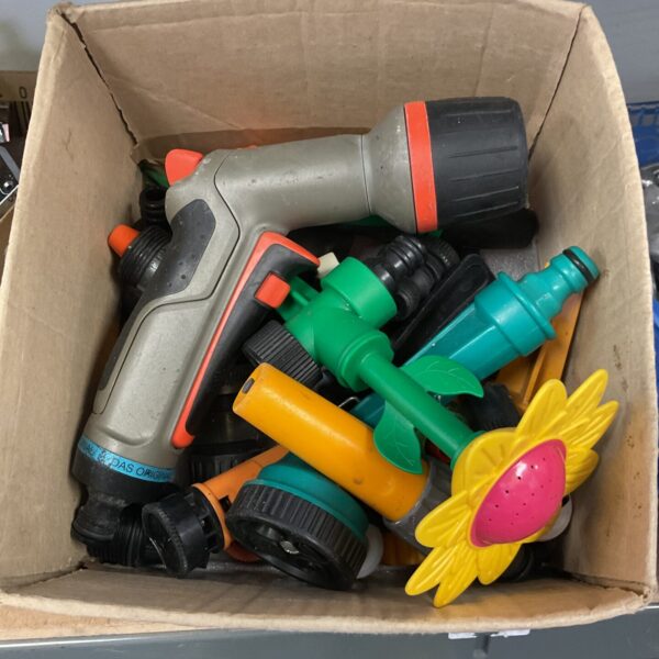 Assorted garden hose nozzles and connectors in a mixed lot.