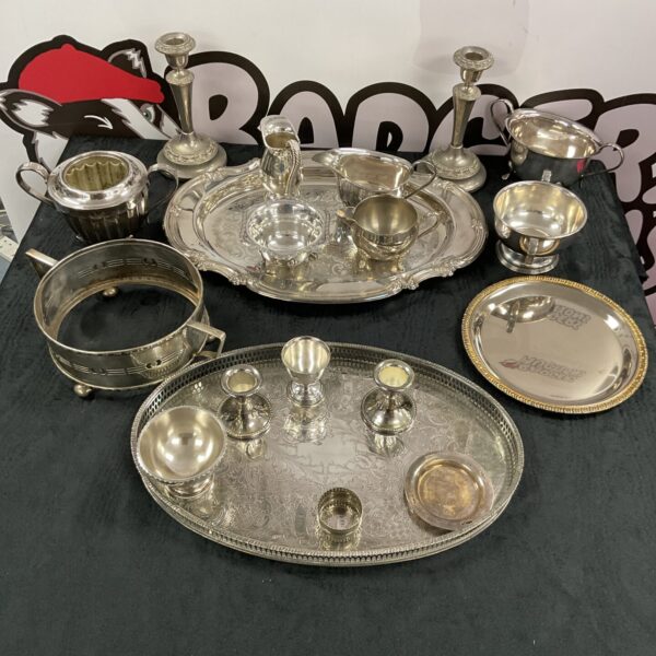 Vintage silver plate collection featuring trays and cream jugs.