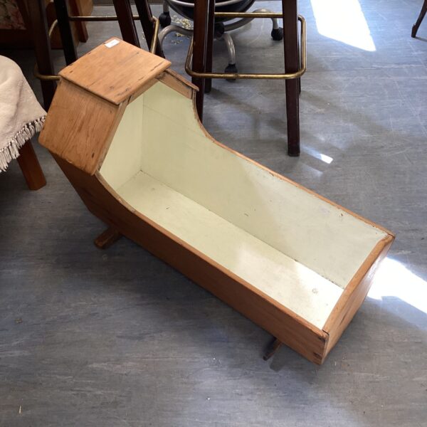 Antique Victorian rocking cradle, side view.