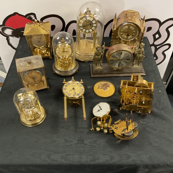 Vintage clock collection with Schatz movements and timepieces.