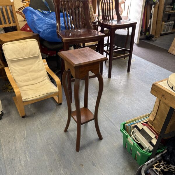 Vintage mahogany plant stand with three tiers.