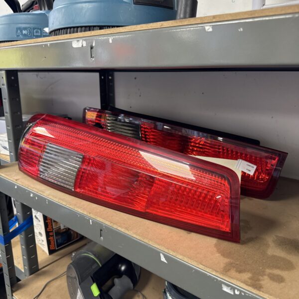 Pair of red Ford Fiesta Mk6 rear lights for automotive repair.