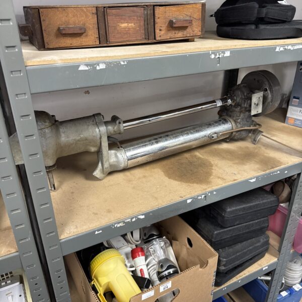 Vintage Seagull outboard motor on a shelf, awaiting restoration.
