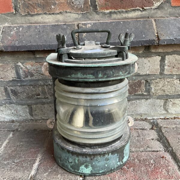 Antique ships mast lantern with brass frame and glass panes.