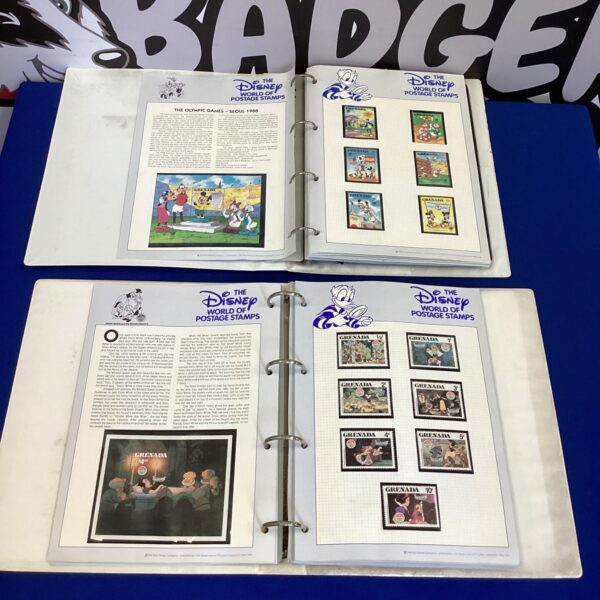 Two open Disney stamp albums filled with colourful vintage stamps.