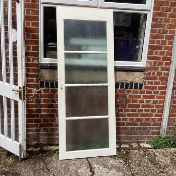Vintage white fire door with glass panels, measuring 6’6” x 30”.