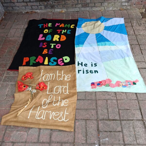 Group of three vintage church banners with religious lettering.