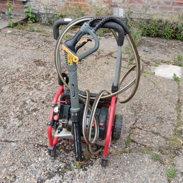 Red and black Homelite pressure washer with hose and lance.