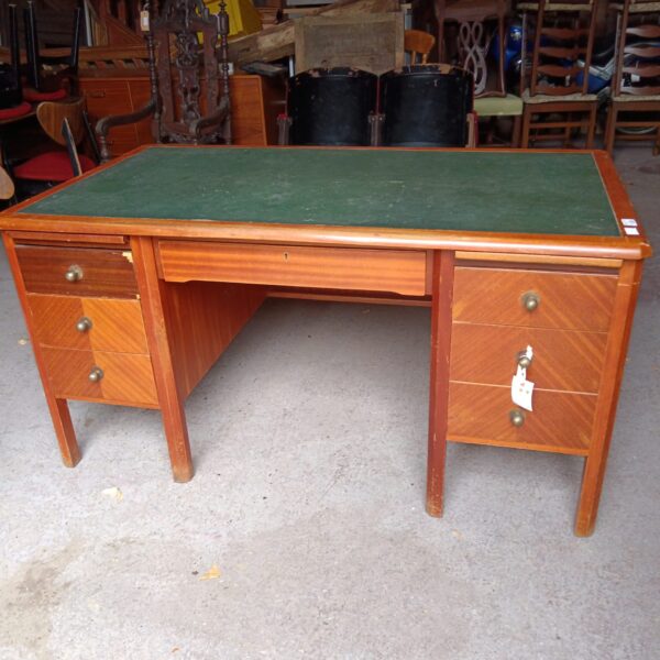 Antique mahogany desk with green leather top and drawers.