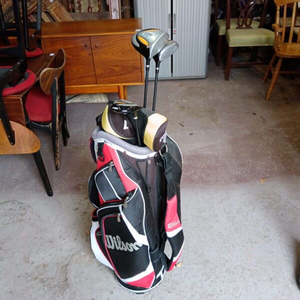 Vintage Wilson golf bag with three CGI clubs.