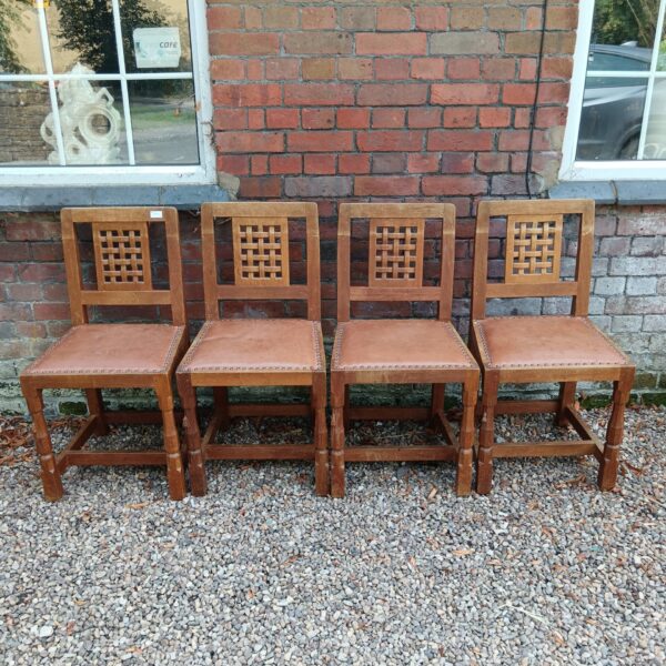 Set of four Robert Mouseman oak chairs with lattice backs.