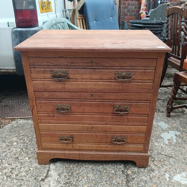 Vintage wooden three-drawer chest of drawers for bedroom storage.