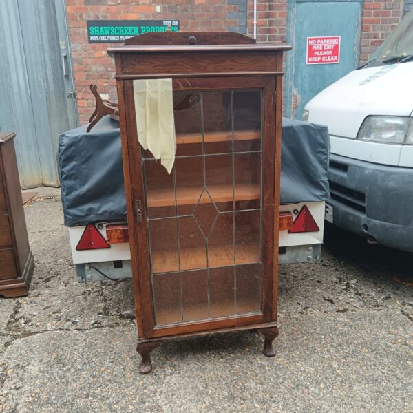 Antique Victorian mahogany glass display cabinet for collectibles.