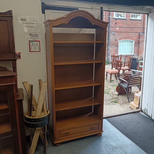 Vintage full length pine bookcase with multiple shelves.