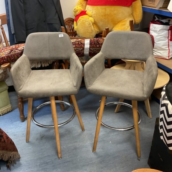 Pair of grey swivel bar stools for kitchen island seating.