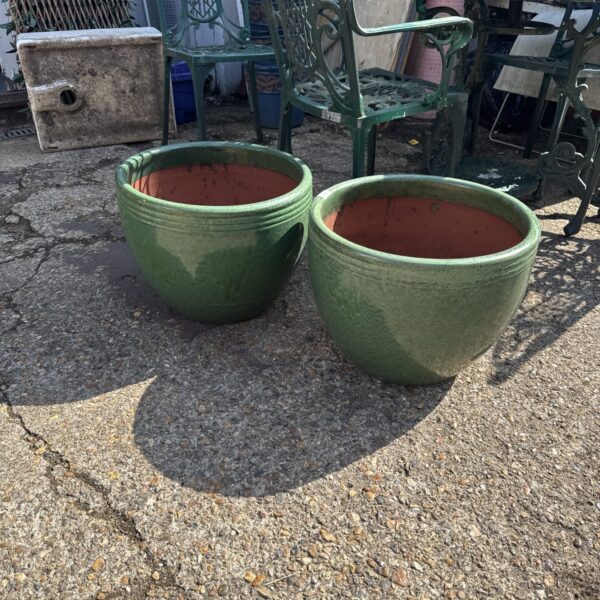 Lot of two large glazed terracotta planters for garden use.
