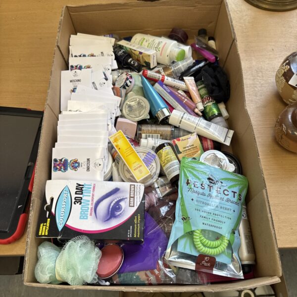 Tray of assorted makeup and perfume samples, a beauty product collection.
