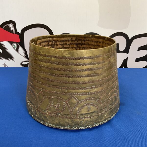 Antique Islamic brass pot on wooden base, vintage metalwork.