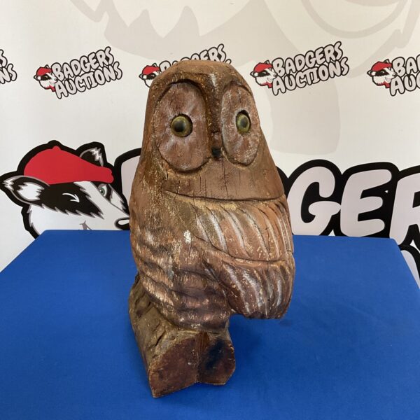 Large carved wooden owl garden ornament with detailed feathering.