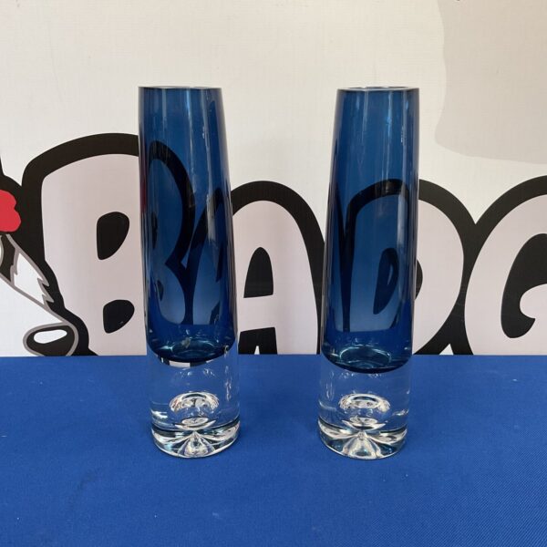 Pair of vintage Asea Glasbruk blue glass vases on a white background.