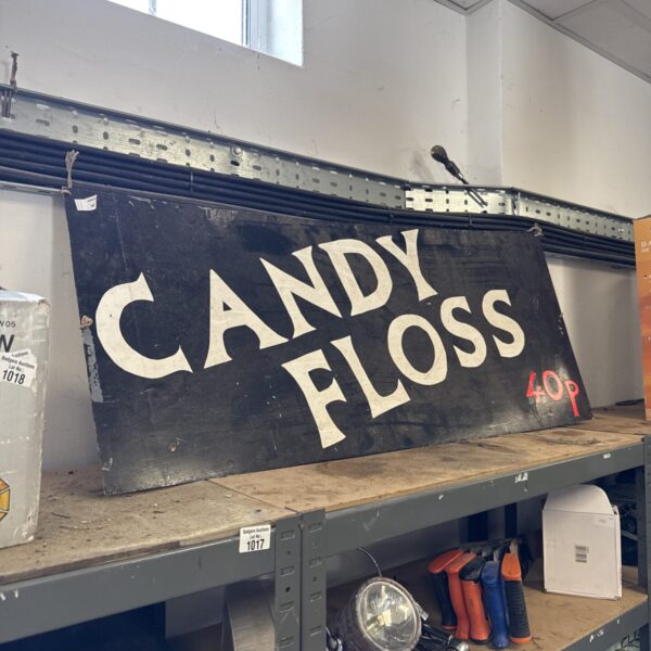 Large vintage candy floss sign with faded paint and rust.