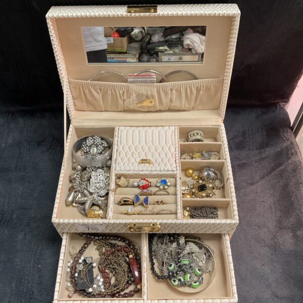 Vintage jewellery box filled with costume jewellery and accessories.