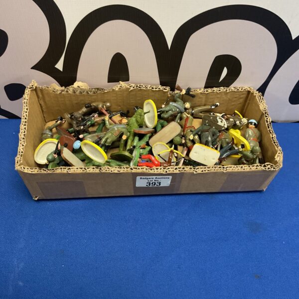 Vintage plastic toy soldiers in a box, collectible military figures.