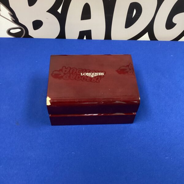 Vintage red Longines jewellery box with logo detail.